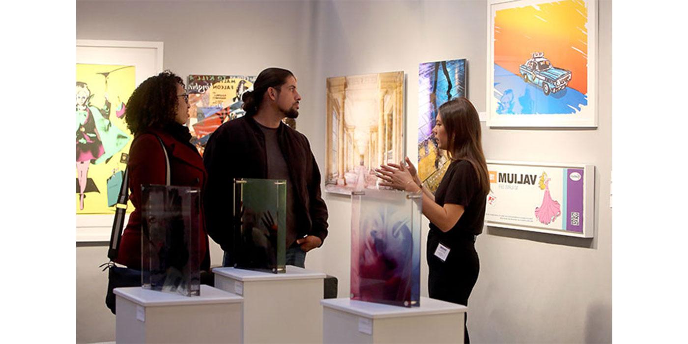 Eventgoers speak to art experts at the Boston International Fine Art Show